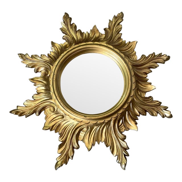 Lovely Mid Century Italian sunburst mirror with a surround of scrolling 'rays' of alternating lengths. This attractive...