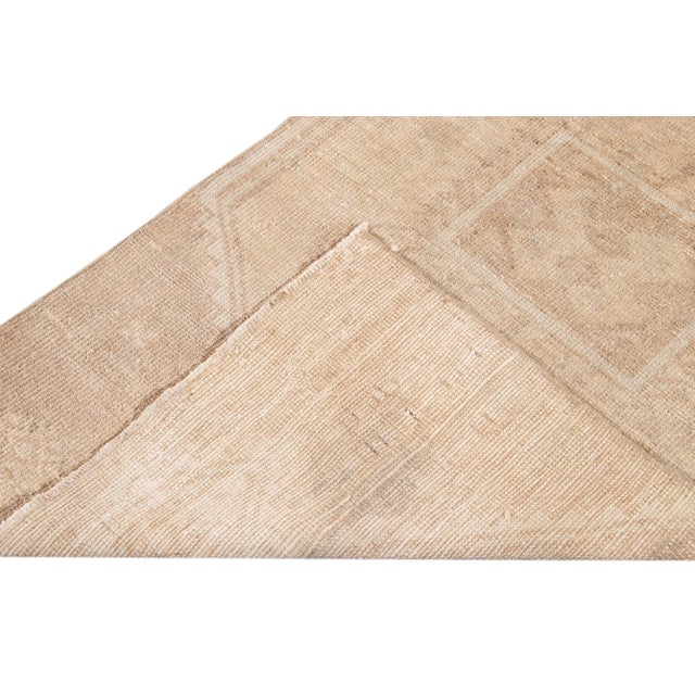 Beautiful vintage Turkish hand-knotted wool runner with a beige field. This piece has peach accents in an all-over...