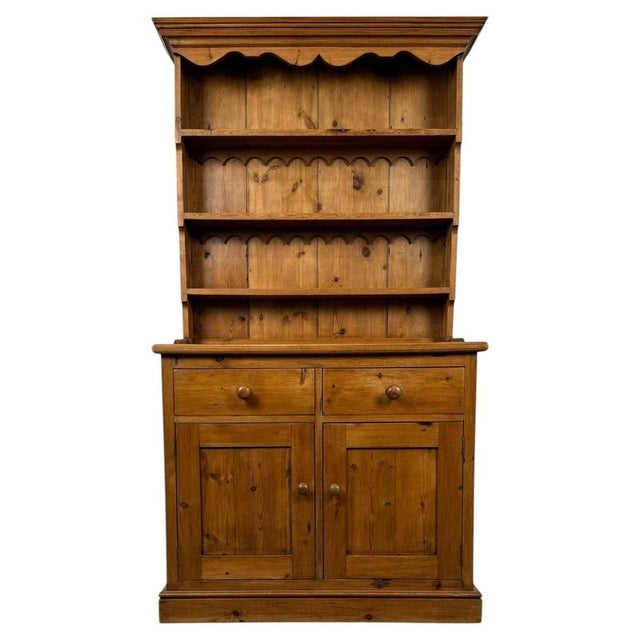 A handsome vintage 20th-century English country dresser, beautifully constructed from pine and combining generous display...