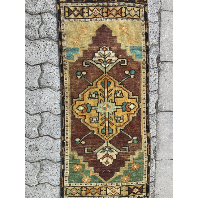 This is a vintage Turkish Oushak rug from the 1960s. The piece was hand-knotted.