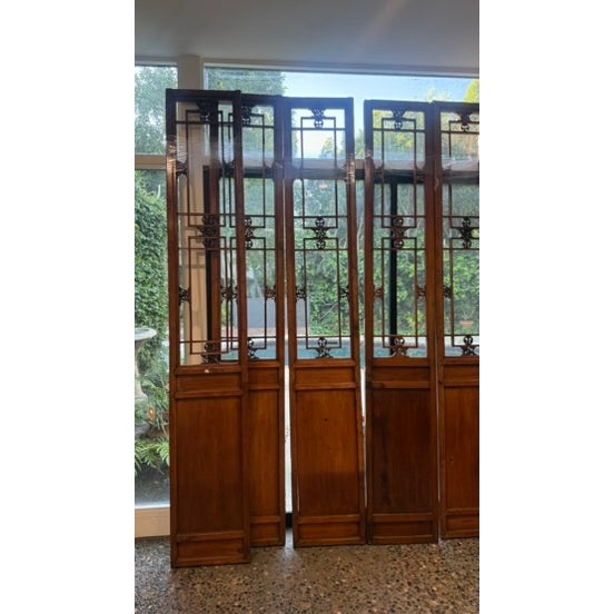 A rare and highly decorative set of monumental Chinese elm architectural lattice panels, each standing an impressive 110...