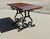 Strong Attractive Cast Iron and Oak Garden Table This lovely table stands on an elaborate iron base, the top of the table...