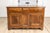 An Italian walnut buffet from the early 19th century, with three drawers over two doors, carved diamond motif and...