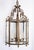 A large, octagonal lantern with glass enclosure, c. 1900, French. Frame, finals, and scrollwork are solid brass. Glass...