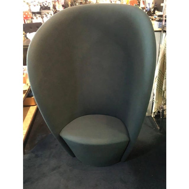 A beautiful sculptural design from powerhouse design team Busk + Hertzog, Shelter is a high profile lounge chair centered...