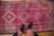 :: Single column repeating diamond shaped medallions atop a heavily abrashed field with gem-like quality to the magenta...