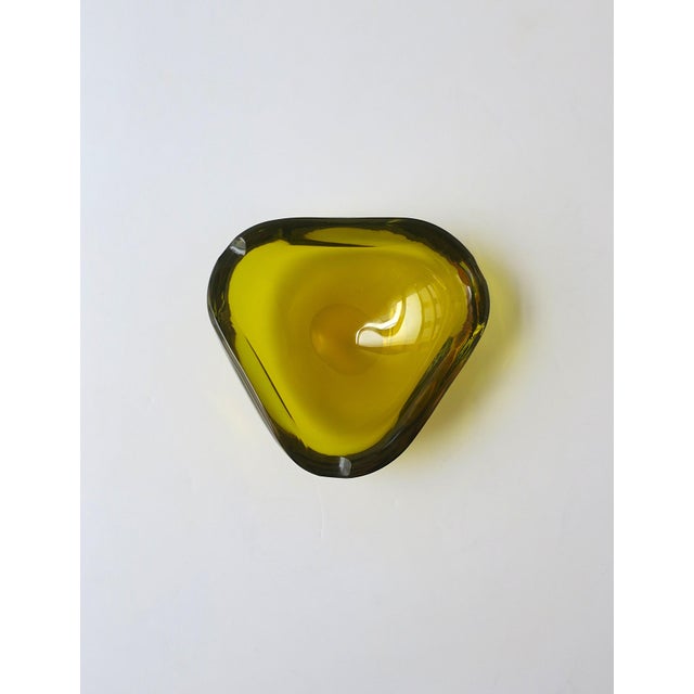 A substantial Italian Murano art glass bowl or ashtray in a transparent golden yellow hue, Midcentury Modern design...
