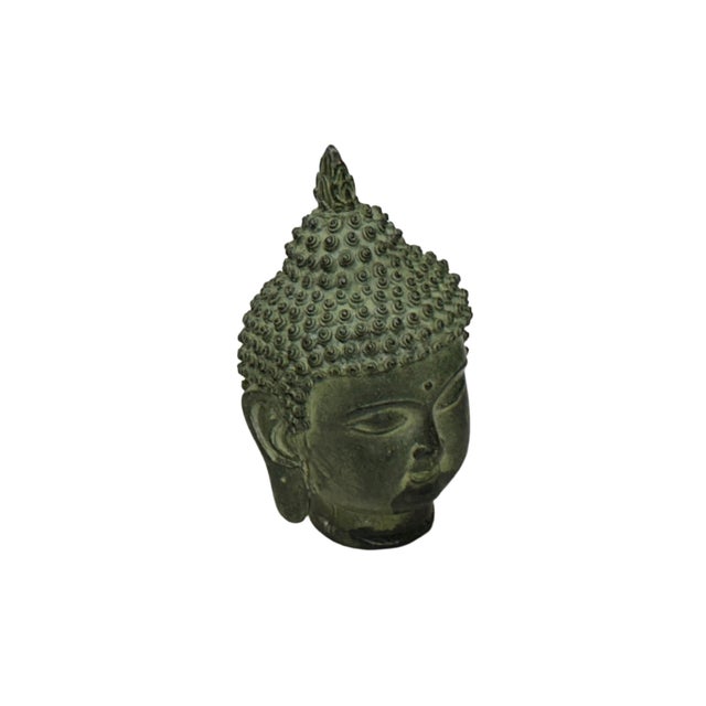 This weathered Buddha head sculpture is captured from multiple angles, showcasing a serene and meditative aesthetic. Cast...