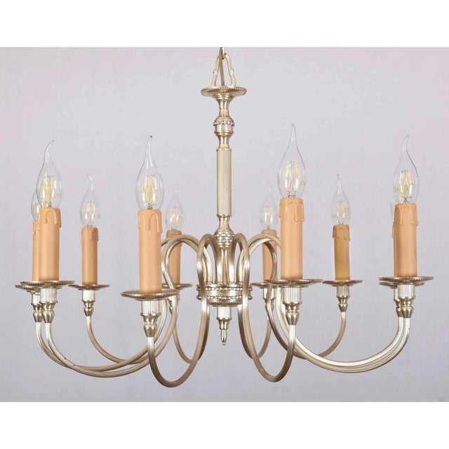 Ten-arm chandelier from the 1960s with subtle decoration. The chandelier has undergone a complete renovation of the...