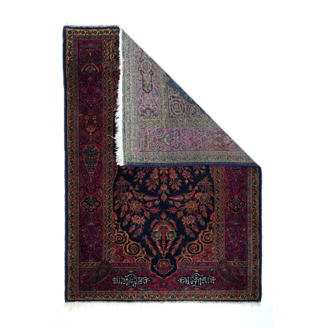 The niche shaped navy field is based with a vase spreading luxuriant multi-flower stems, with a floriated lamp at the...