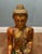 A large and impressive carved wooden seated Burmese Buddha figure, richly decorated with gilt and polychrome decoration...