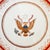 A mid-century Chinese Export porcelain armorial plate depicting a rendition of the Great Seal Of the United States....