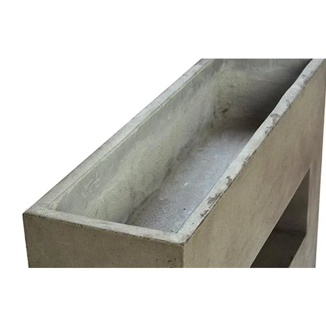 Modern architectural planter featuring a clean geometric silhouette with open center detail. Suited for contemporary...
