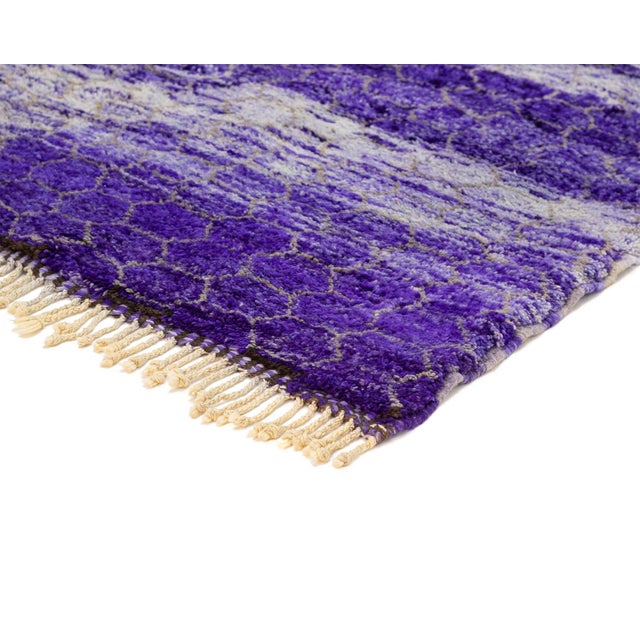 A rug that catches the eye instantly — a repeating honeycomb texture rendered in deep, saturated purple, breaking into...