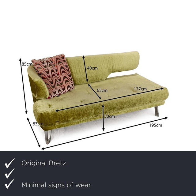 The Croissant sofa by Bretz is covered in green and patterned fabric and stands on slightly angled metal legs. The three-...