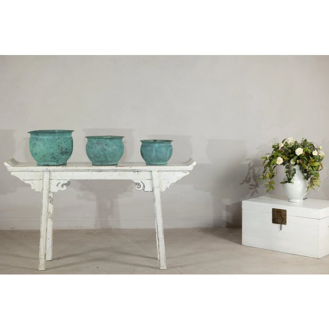 This captivating set of three vintage copper cache pots, handcrafted in India, brings a warm, timeworn elegance to any...