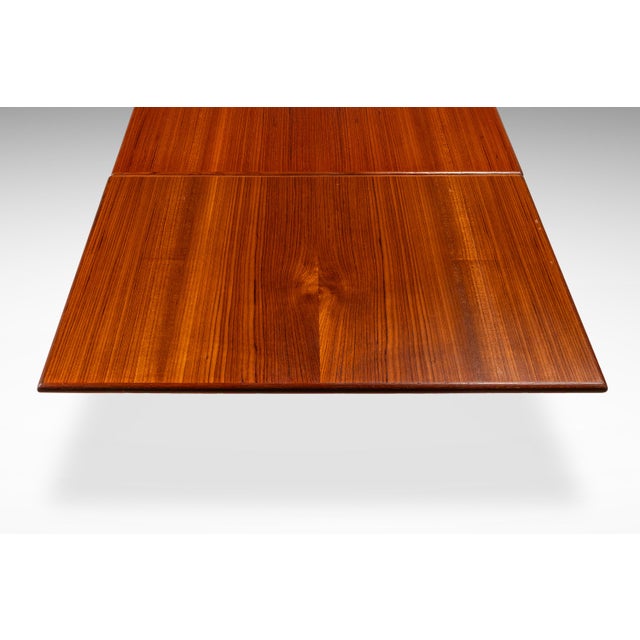 This elegant Danish Mid-Century Modern expansion dining table, attributed to Johannes Andersen for Udlum Mobelfabrik in...