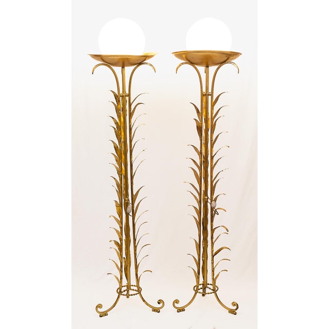 Set of two Art Deco floor lamps, gilded with gold leaf. White opaline glass globes. Rewired, long floor cable (3 m)....