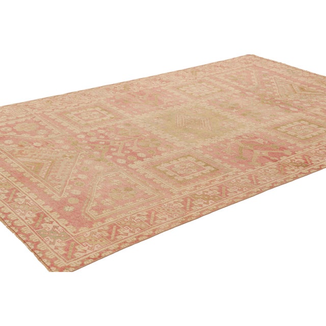 Hand-knotted in wool, this 7x11 vintage Turkish rug, circa 1950-1960, features interesting soft colors for a work of its...