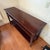 Elegant and substantial solid wood console table originally purchased from Sprintz Furniture. Crafted with a rich dark...