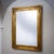 Large vertical wall mirror in a gilt and molded Empire frame with applied stucco decoration. The mirror plate is of a...