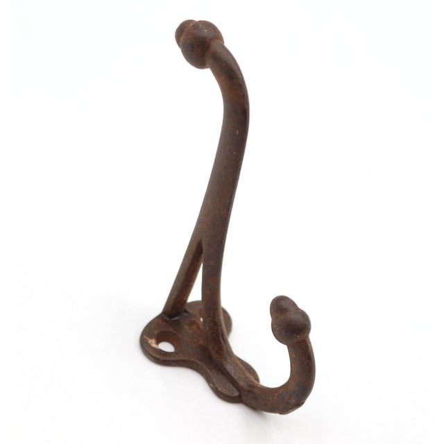 Vintage cast iron double arm acorn wall hook with a black finish. The original mounting screws are not available. Good...