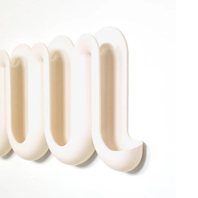 Transform your home’s entrance into a fun and multi-functional space with the whimsical wave-like Heller® Swell™ wall-...