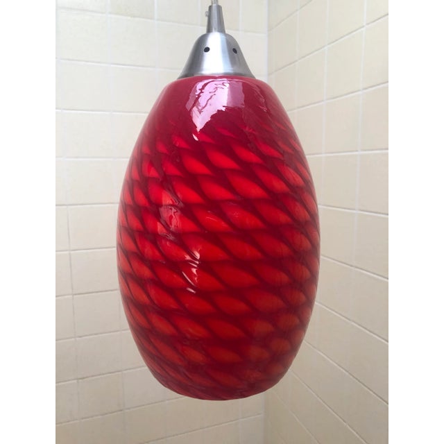 The glow of this pendant light looks like a basket weave of orange and red. Done in hand blown artist glass. Great in a...