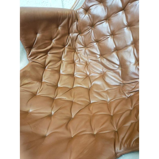 An iconic Space Age "Jetson" chrome and leather swivel armchair, made by Bruno Mathsson for DUX in the 1970s. Resting on a...