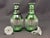 Emerald Green cut to clear, pair crystal decanters. Hand-blown and hand-cut. Ribbed cutting on sides. Starburst cut base....