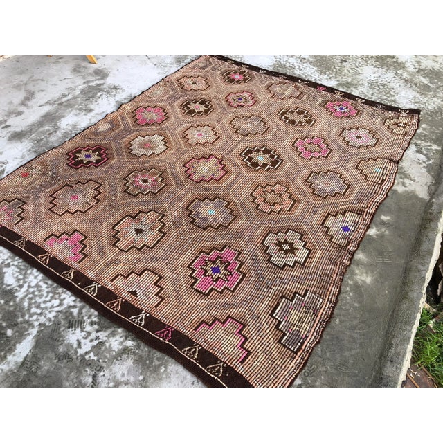 This is a vintage Turkish Anatolian kilim rug from the 1960s. The piece was hand-woven.