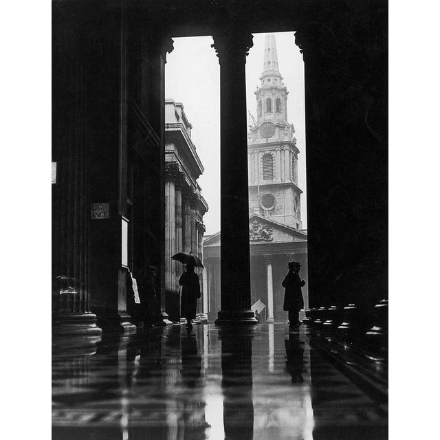 Sheltering From Rain February 1928: People sheltering from the rain under the portico of the National Gallery in London....