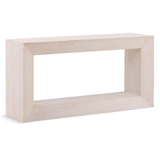 Simple yet impactful whitewashed reclaimed pine console table. Waterfall silhouette and open-frame design creating a...