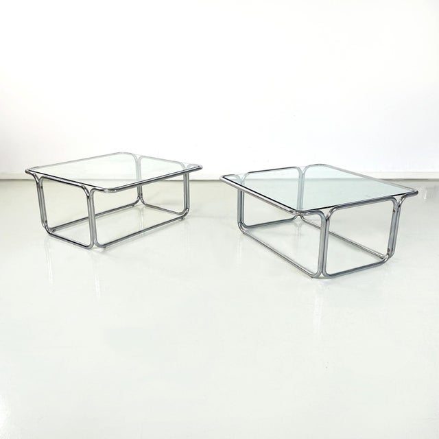Italian modern Square Coffee tables in glass and chromed steel, 1970s Pair of coffee tables with square glass top. The...