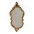 French vintage gold-tone mirror featuring a decorative crest and acanthus leaf detailing; the frame is made of plaster and...