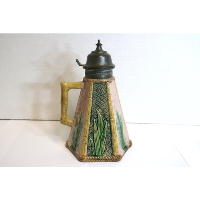 This syrup pitcher is outlined in a bamboo design and the divided bamboo sections are decorated with alternating pink and...