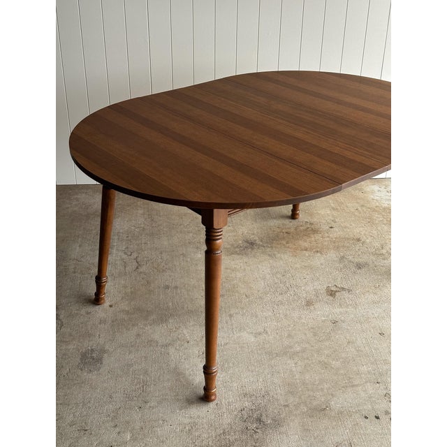 Vintage oval extension dining table by Tell City Chair Company with two optional leaves, solid wood frame and a durable...