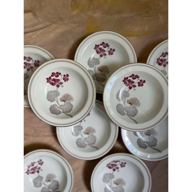 Lovely set of 9 vintage 5 5/8” berry bowls, made in Japan by Noritake. Presented on a crisp white with a gold rim, a...
