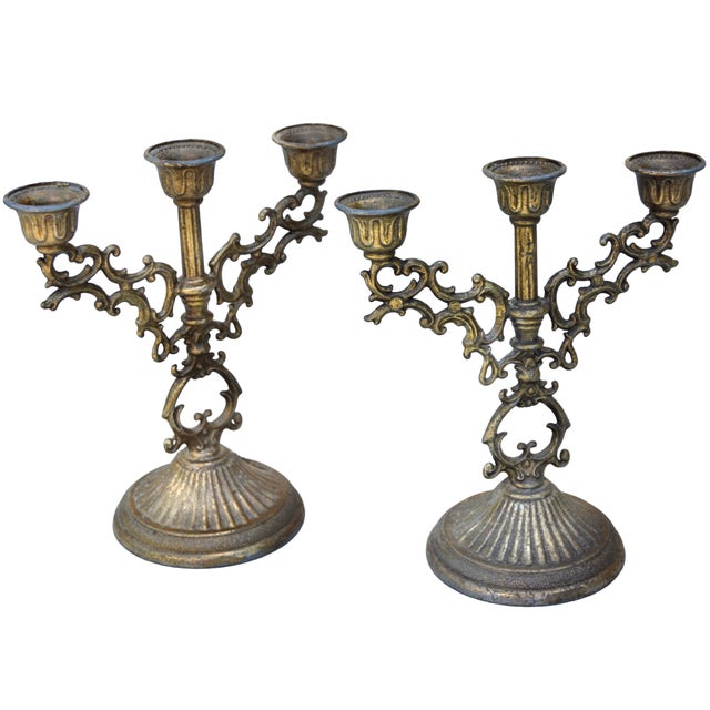 Rare and striking Late 19th Century pair of Italian candleholders meticulously handcrafted of solid brass. Featuring...