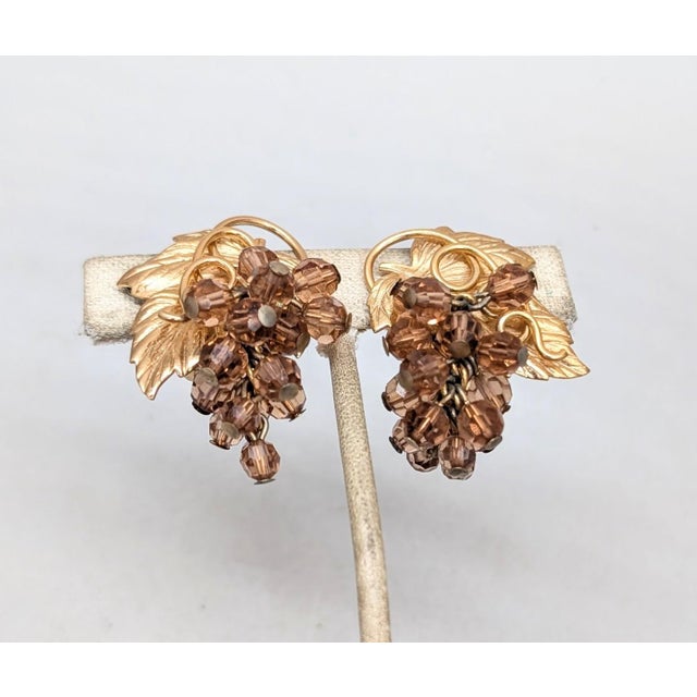 1960s goldtone textured leaf with curled stem top with faceted faux-topaz bead dangle "grape" clusters clip earrings....