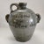 This striking piece is a handmade folk art face jug created by contemporary Georgia potter and educator Stephen Hawks. The...