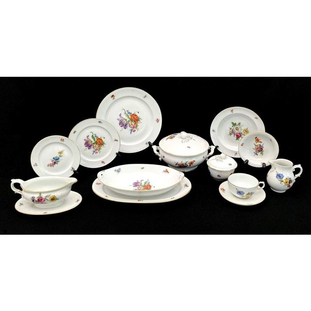 Exceptional set of Furstenberg “Ancestral Dresden” China - 71 pieces White china with center vibrant floral bouquet and...