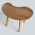 A beautifully sculptural mid-century kidney bean coffee table , crafted in oak and showcasing the organic forms that...