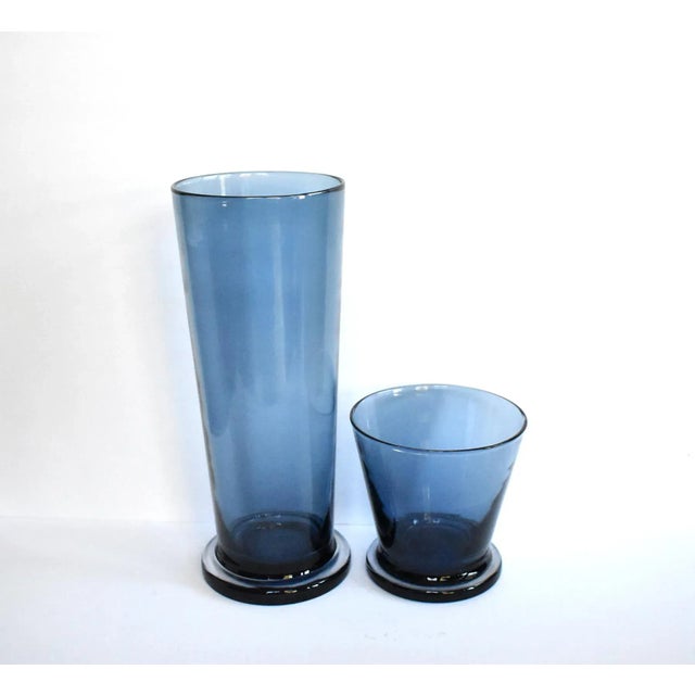 A pair of vintage, mid-century, hand-blown cobalt blue crystal glass vases with a slight tapering on the tall vase and...