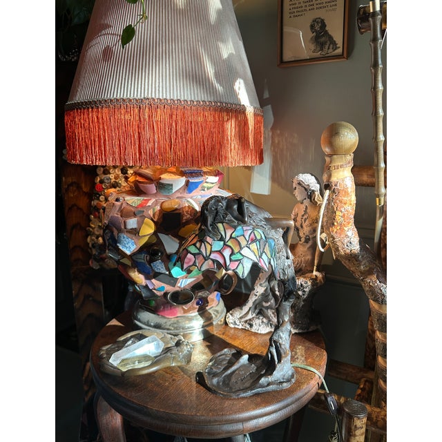 Description E Thomasson stained glass lamp. A figural work depicting the Greek nymph, Daphne, transforming into a bay...