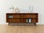 Wonderful sideboard from the 1960s. The body is made of teak veneer with two shelves and new black square steel feet. The...