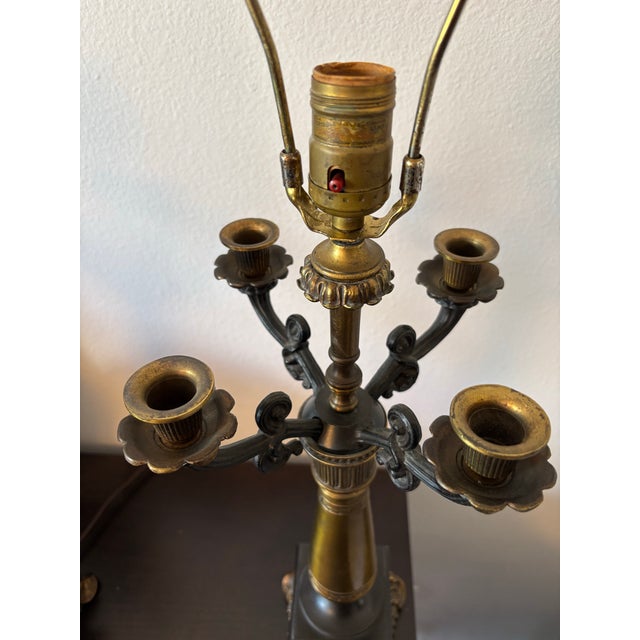 Elegant and substantial pair of vintage four-arm candelabra table lamps featuring richly cast neoclassical styling with...