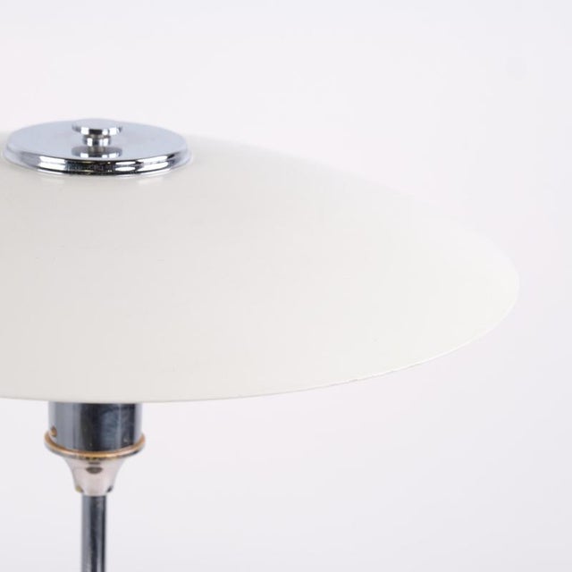 Table lamp by lyfa with white metal shades, nickel-plated frame and brown cord with switch. The lamp dates from around the...