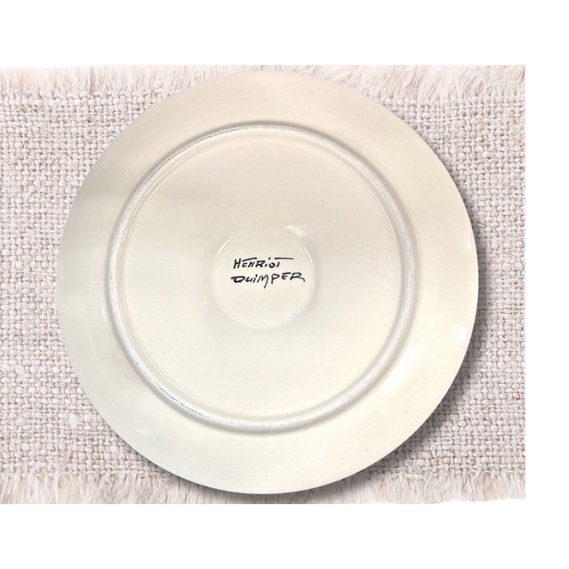A Henriot Quimper oyster plate hand-painted by celebrated artist Guy Trévoux. Finished in the distinctive black faience...