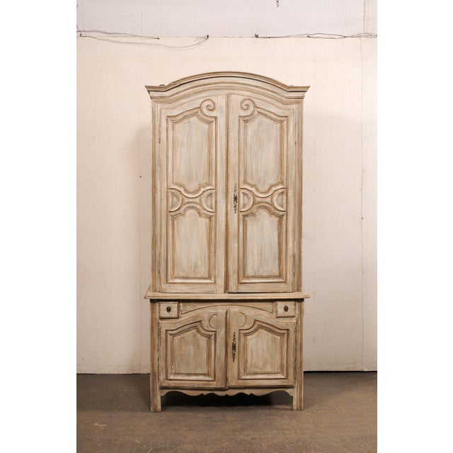 A tall French carved and painted wood storage cabinet from the 18th century. This antique buffet à deux-corps from France,...